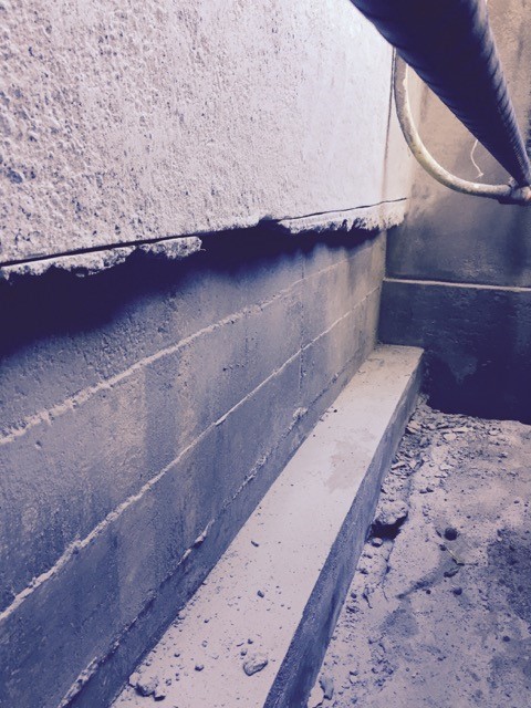 Cutting concrete foundation edge to create square profile