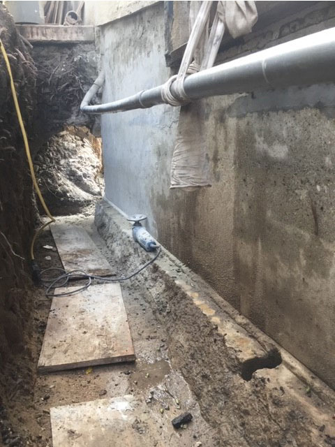 Removing foundation concrete contaminates with surface grinding