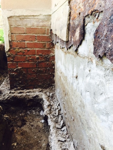 Excavated foundation requiring foundation repairs before waterproofing