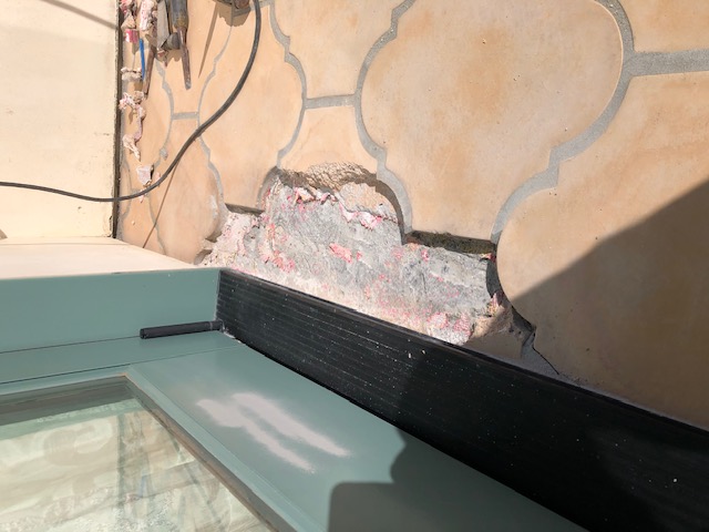 Poor quality under tile membrane applied over deck sloping mortar bed