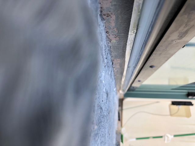 Sealant applied under deck door threshold to prevent interior leaks