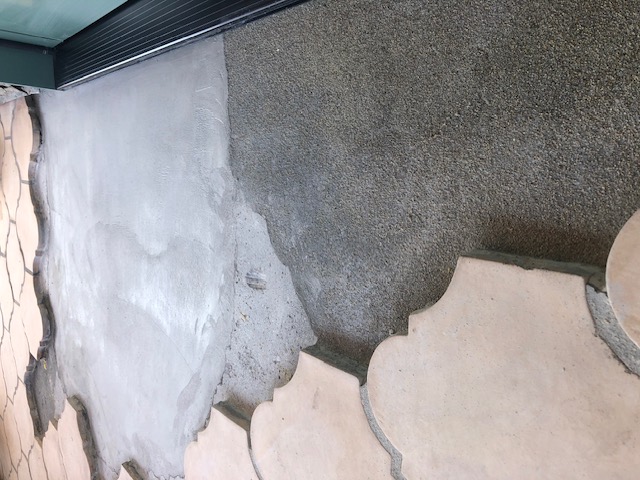 Sloping mortar bed cement applied over restored deck waterproofing membrane