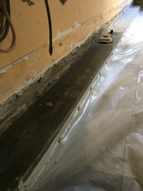 Basement under slab waterproofing connected to sides of footings