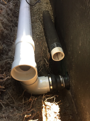 Downspout drainage connected to street curb core