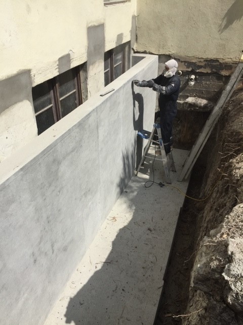 Surface grinding light well foundation prior to waterproofing
