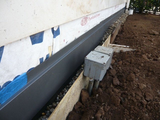 Gravel barrier applied against drainage panels - OC foundation waterproofing