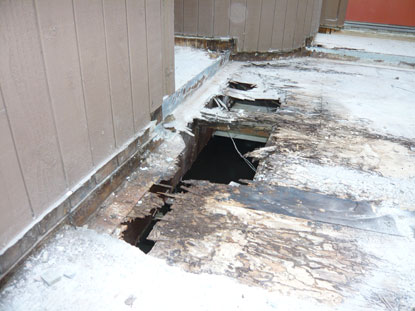 Elevated deck plywood substrate dry rot located above subterranean garage.