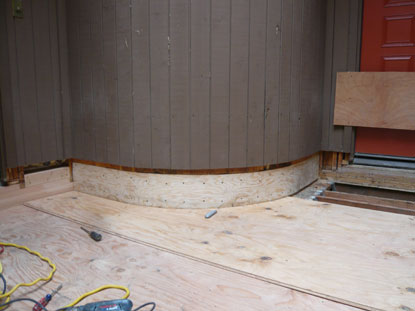 Elevated courtyard deck radius wall 1/4” plywood installation over sill plate structural restoration