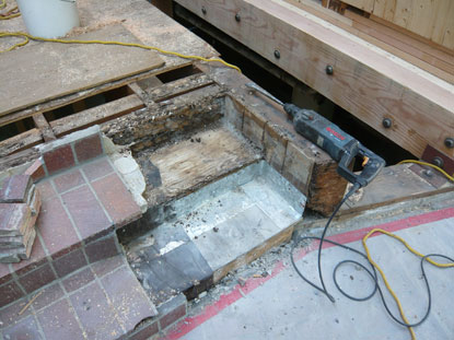 Elevated deck pavers concealed the defective step transition flashing creating structural dry rot, termite damage