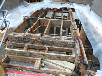 Defective elevated courtyard deck waterproofing creating structural dry rot and termite damage