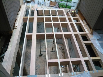 Elevated courtyard deck structural blocking and reinforcement are necessary to control movement