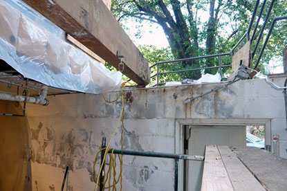 Overview of termite damage to edge of courtyard structural beam
