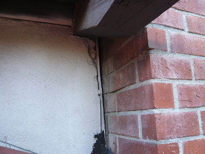 Defective stucco wall and chimney transition flashing.