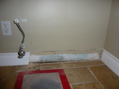 Mold and sewage contamination located behind bathroom baseboard