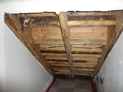 Exterior slate stairway waterproofing failure creating water damage to ceiling under staircase