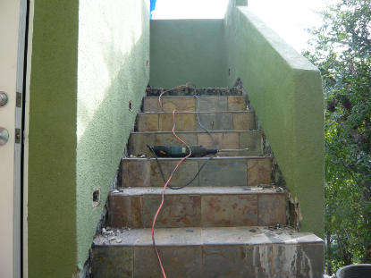 Exterior slate stairway waterproofing failure creating water intrusion and interior mold contamination