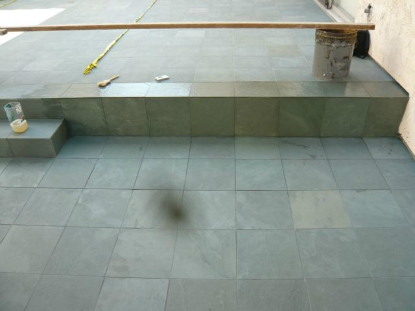 Application of water repellent stone sealer to slate tile and grout
