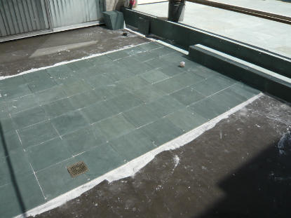 Bronze deck drain installation to elevated slate deck