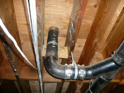 Riser clamp installed to prevent movement at deck drain connection