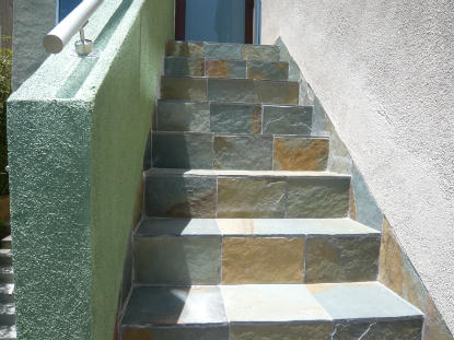 Completed exterior stairway waterproofing including slate installation